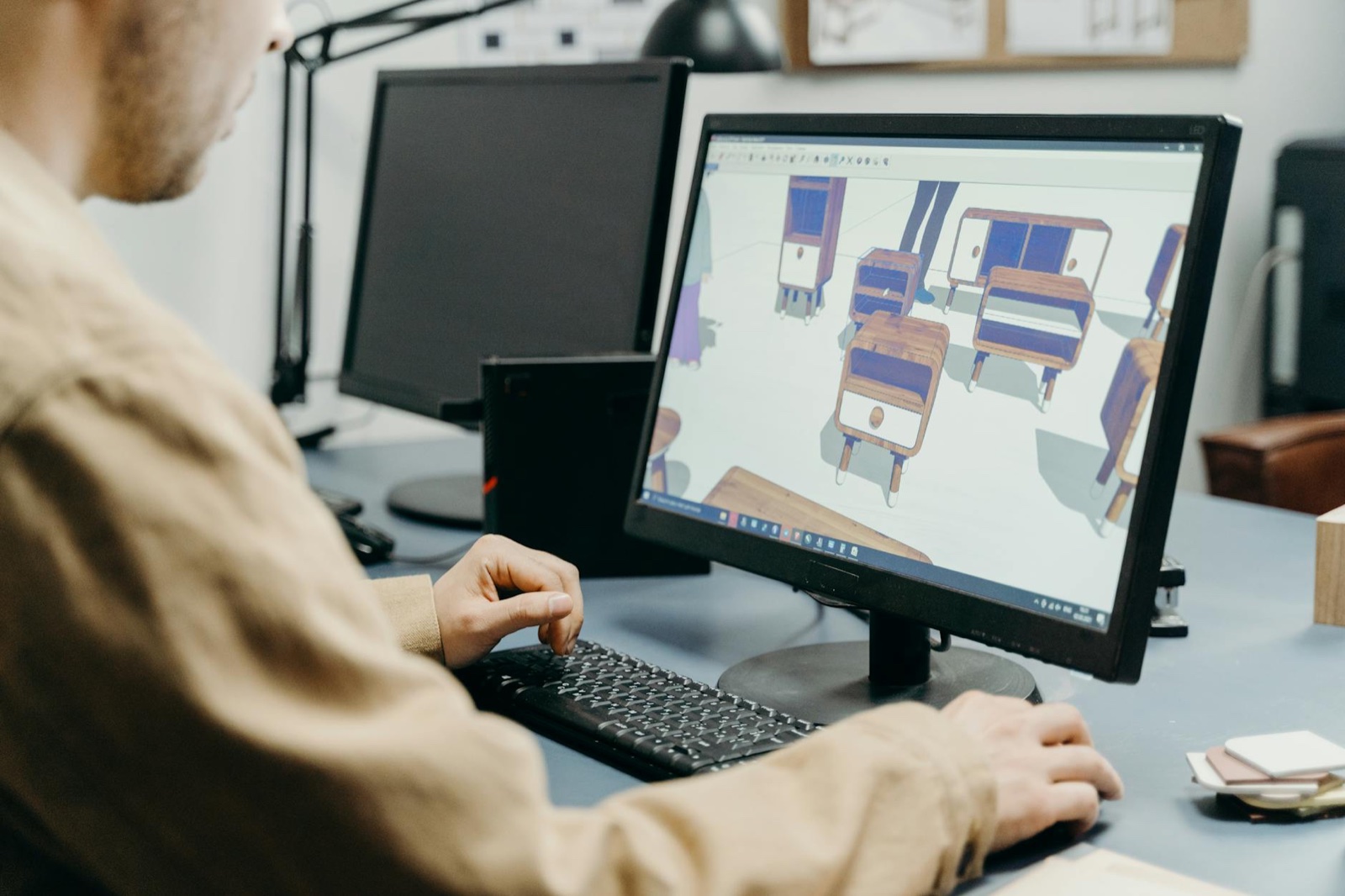 Designer using 3D rendering software guide workflow on a workstation