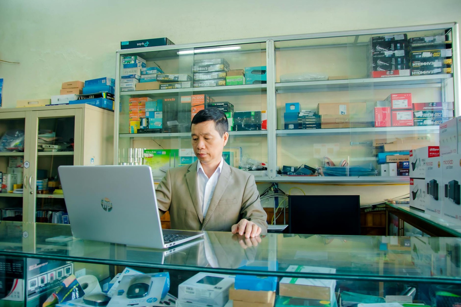 Small business owner reviewing 3D product visuals on a laptop