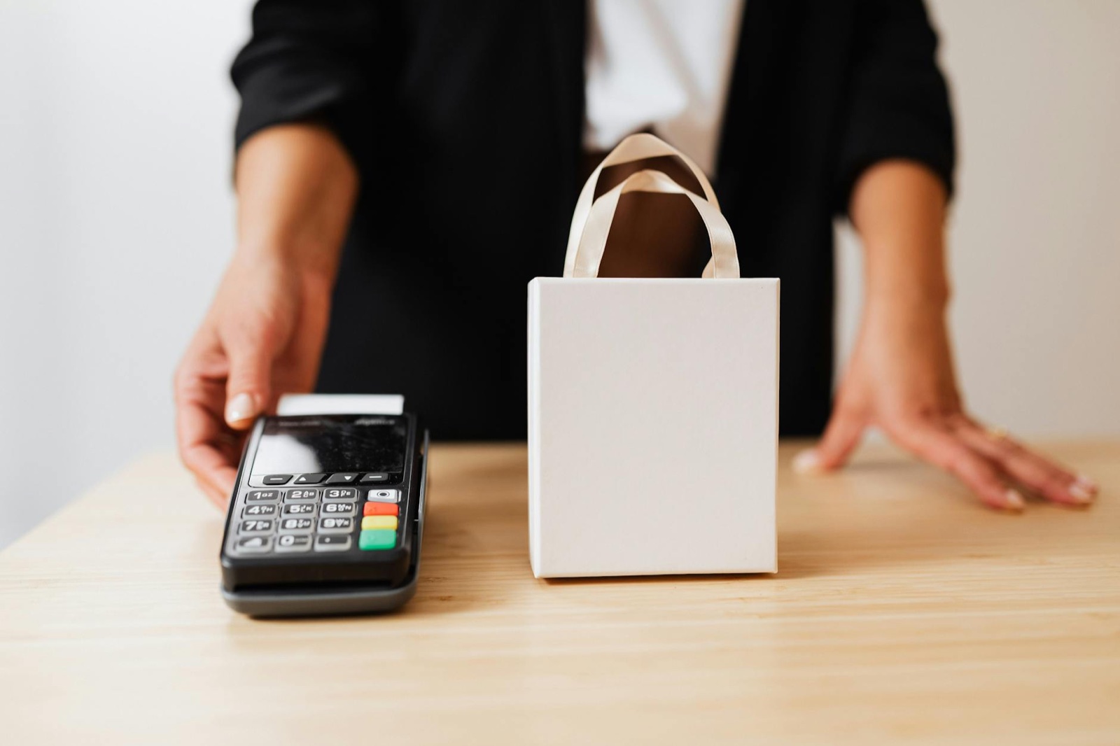 Small business owner processing online order with payment terminal