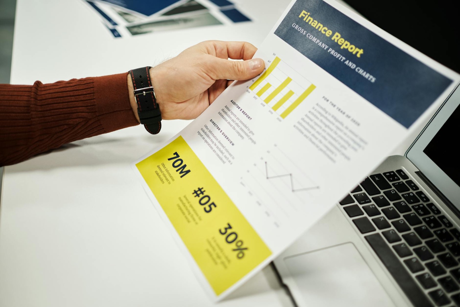 Small business owner reviewing Google Ads search terms report on laptop