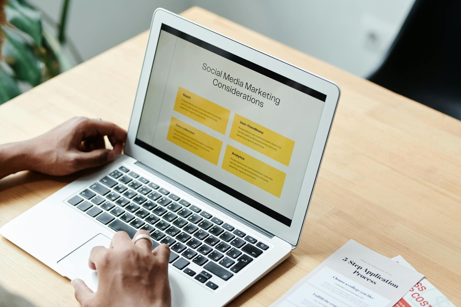 Marketer using ai writing tools on laptop to enhance content marketing strategy
